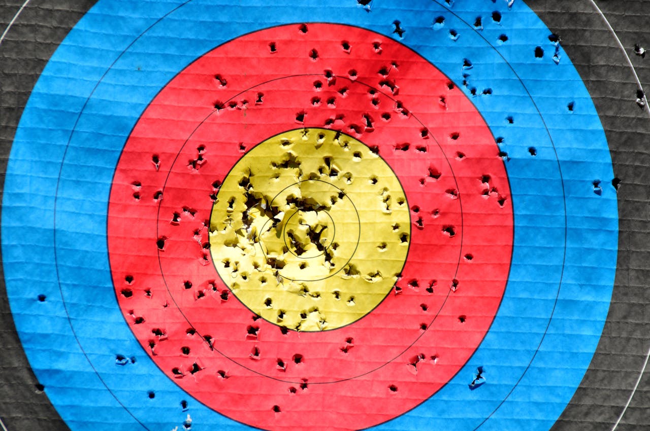 Vibrant archery target showcasing accuracy with multiple hits across colored rings.